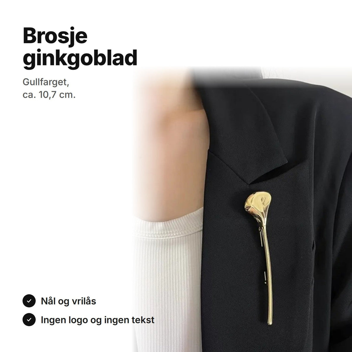 Gullfarget brosje formet som et ginkgoblad, festet på en svart blazer
