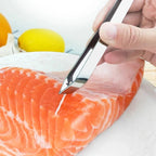 Fiskepinsett med skrå spiss trekker et bein ut av en laksefilet