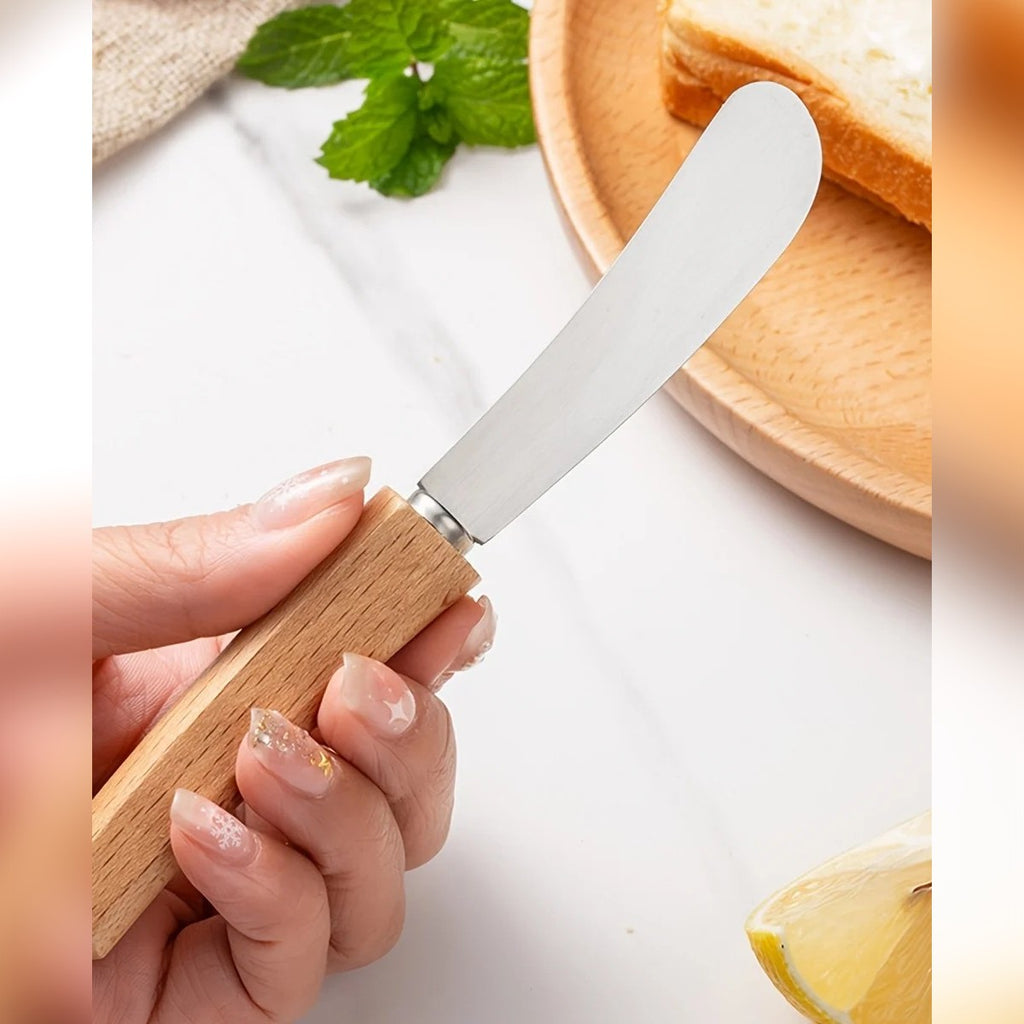 Smørkniv med treskaft holdt i hånden