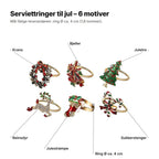 Serviettringene forklart: krans, bjeller, juletre, reinsdyr, julestrømpe og sukkerstenger på gullfargede ringer, Ø ca. 4 cm