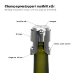 Champagnestopperen forklart: hette i rustfritt stål, hengsel og 2 vinger som griper under kanten på flasken, vinger ca. 55 mm