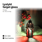 Svart lyslykt med farget glass til telys, ca. 15,5 cm høy, med dør i siden og ring til oppheng