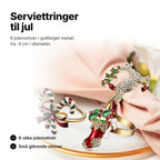 Serviettringer til jul i gullfarget metall med sukkerstenger, julestrømpe og reinsdyr ved en rosa serviett – Ø ca. 4 cm, 6 motiver